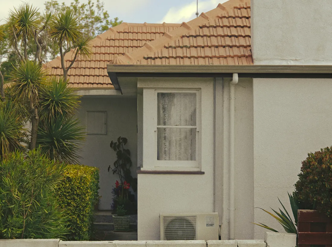 A Ryde home with a tiled roof, established garden and exterior air-conditioning unit